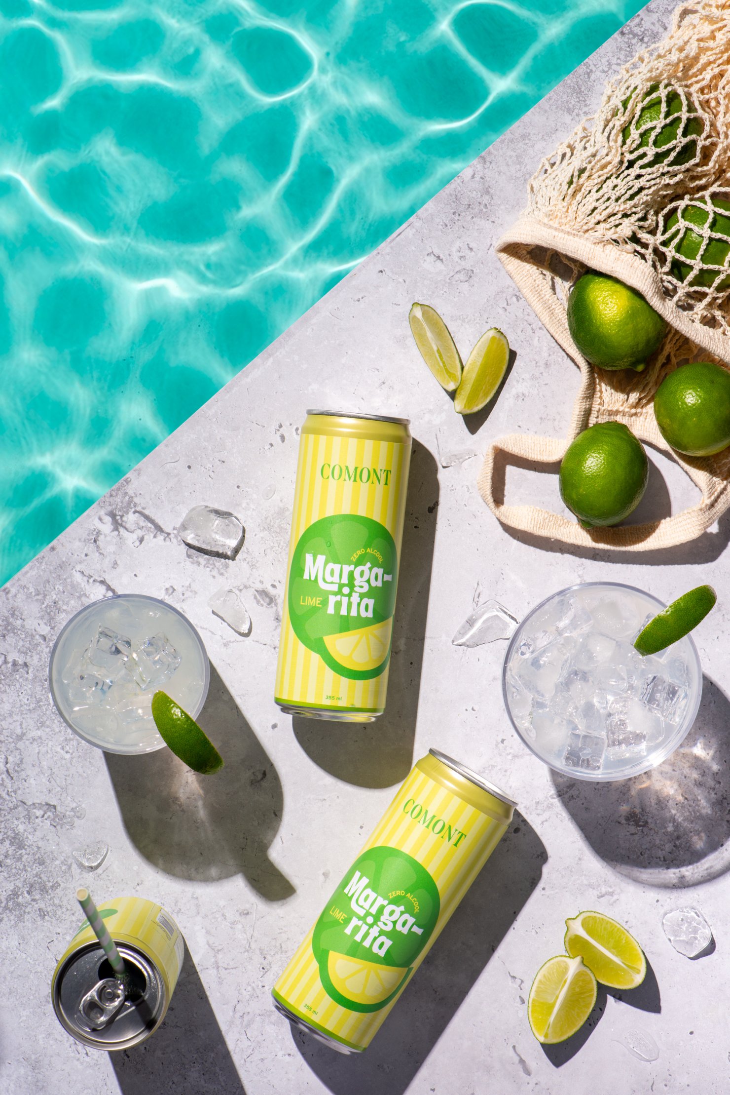 Two cans zero alcohol Modern product photography of Comont margarita product on pool side with limes
