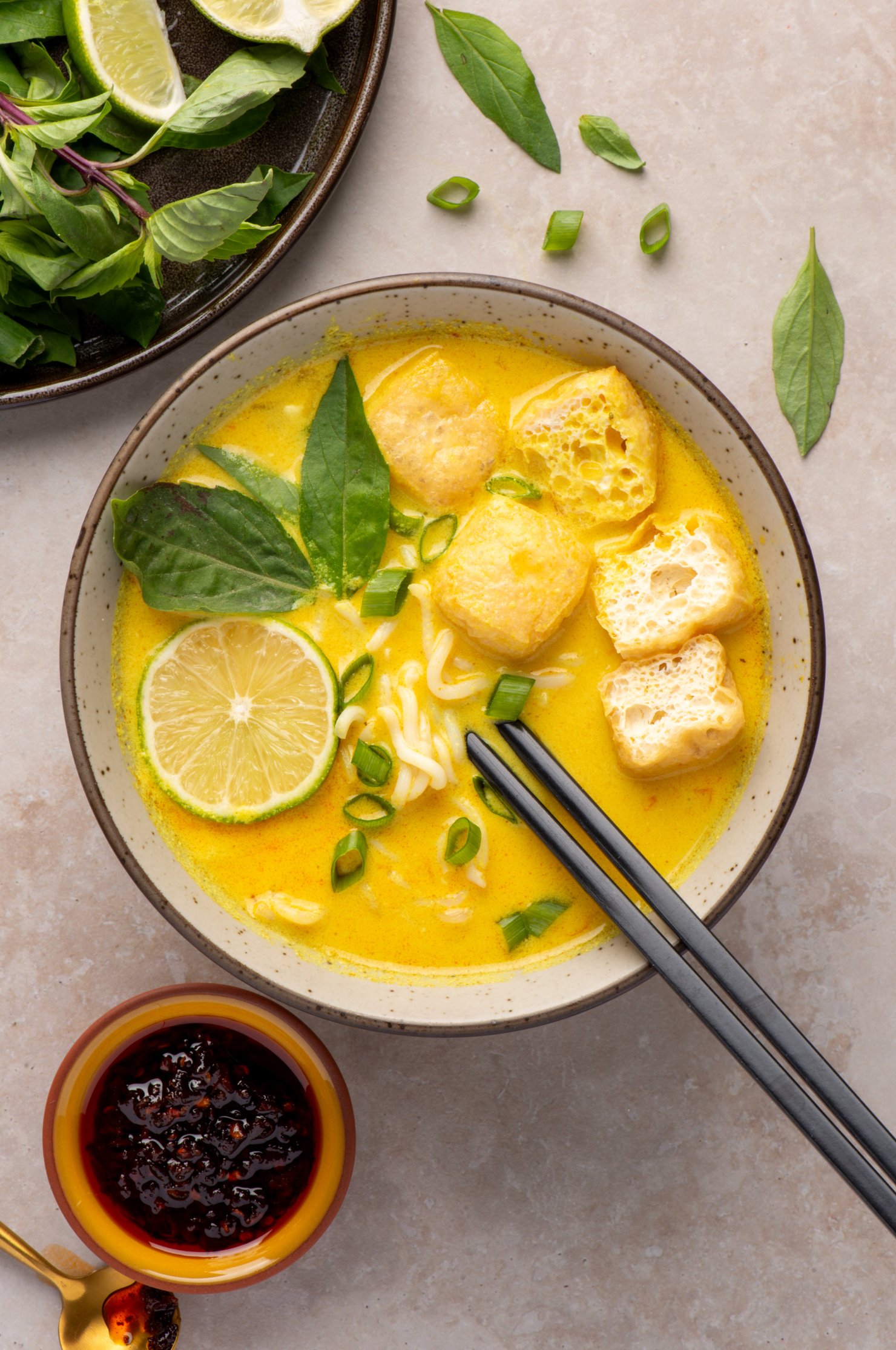 Ramen laksa with tofu puffs, thai basil, lime and chili crisp