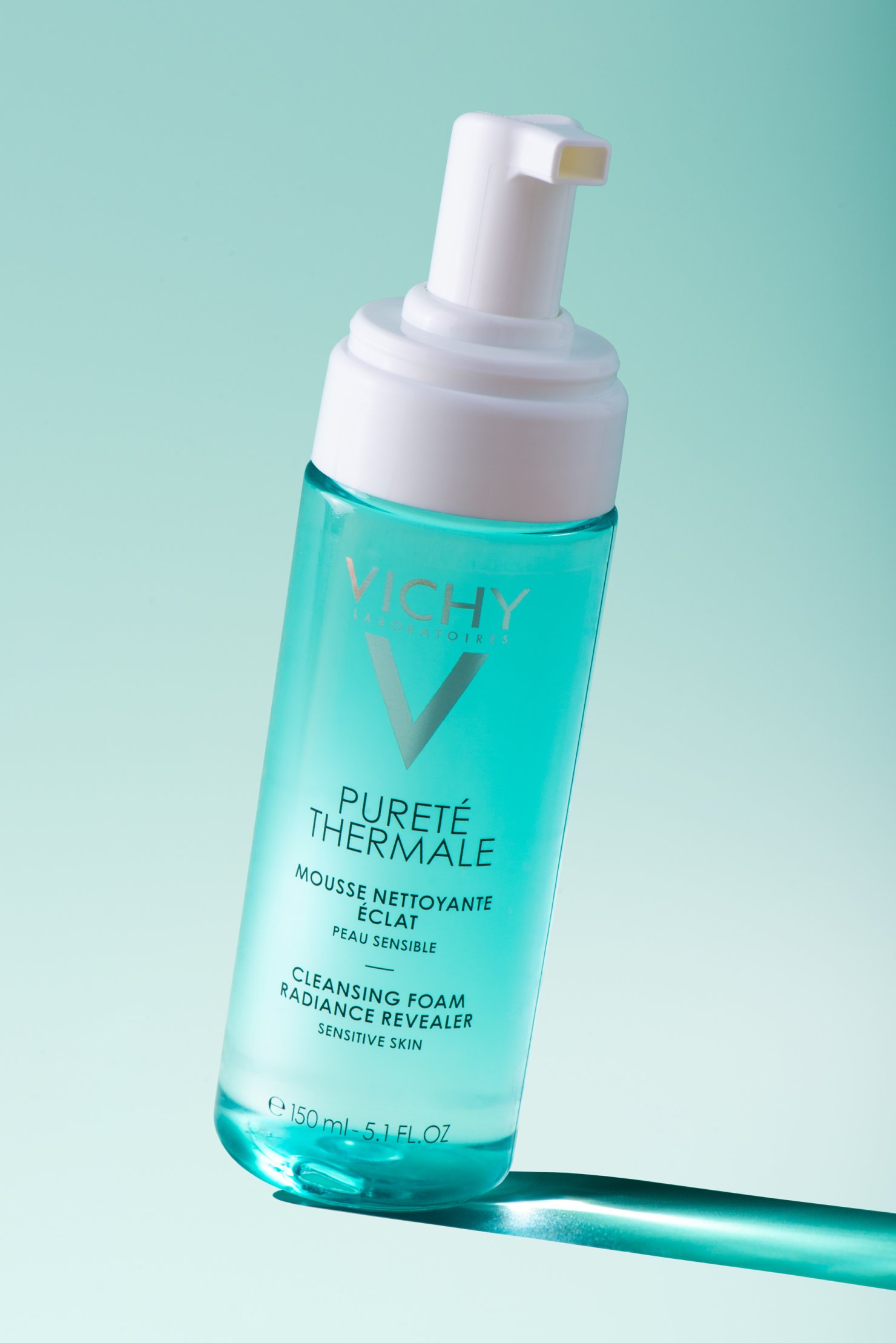 Vichy Pureté Theremale facial cleanser bottle on side with dramatic blue shadow
