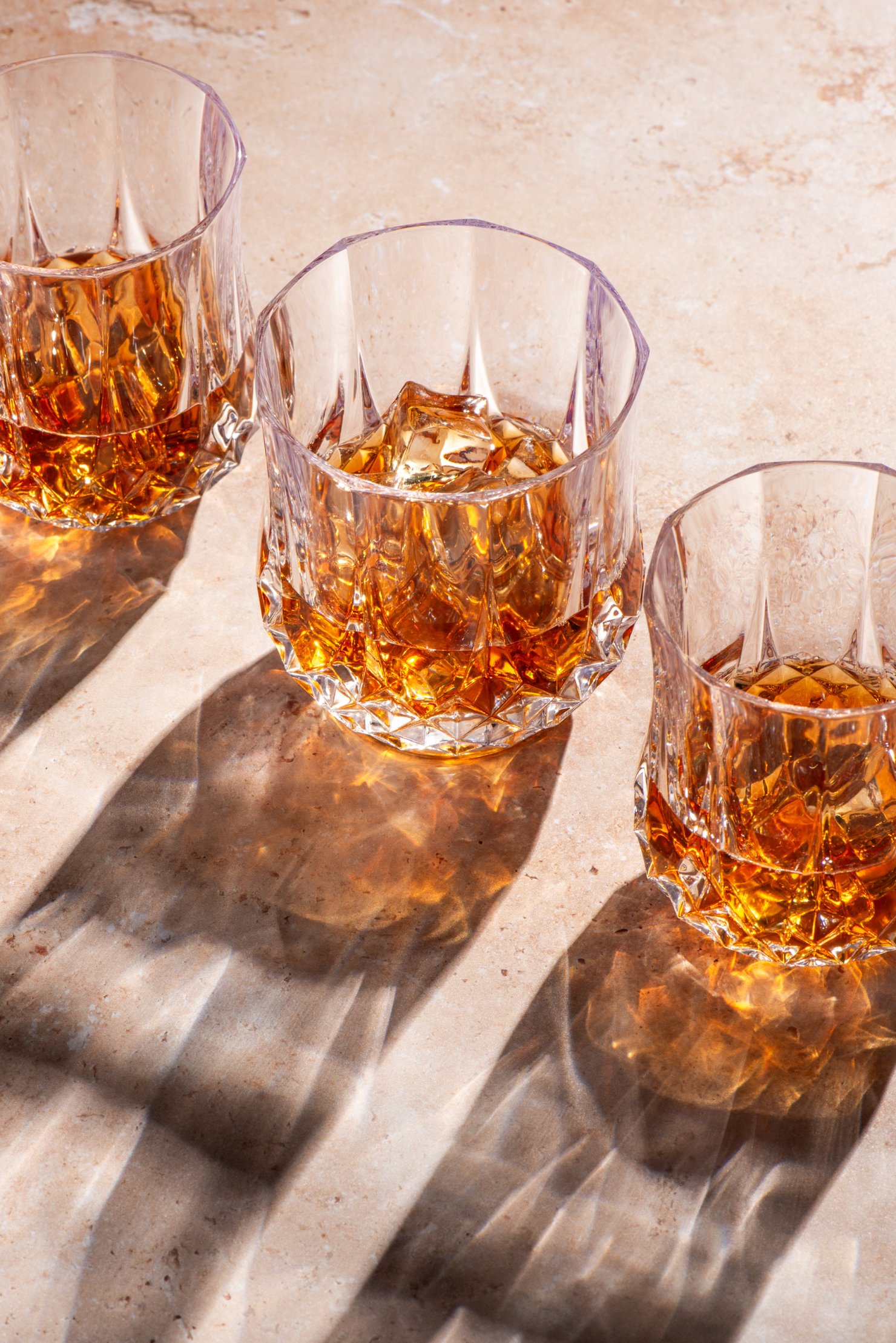 Drinks photography by Montreal photographer Mel Discepola, 3 glasses of scotch with play of shadows